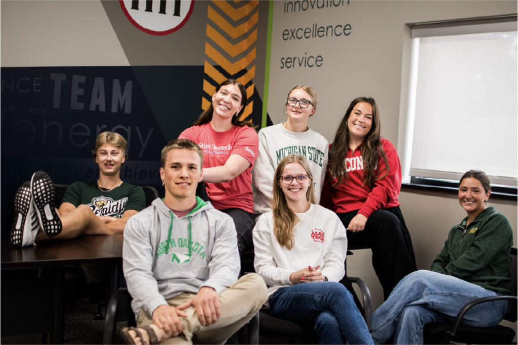 Image of college students around table