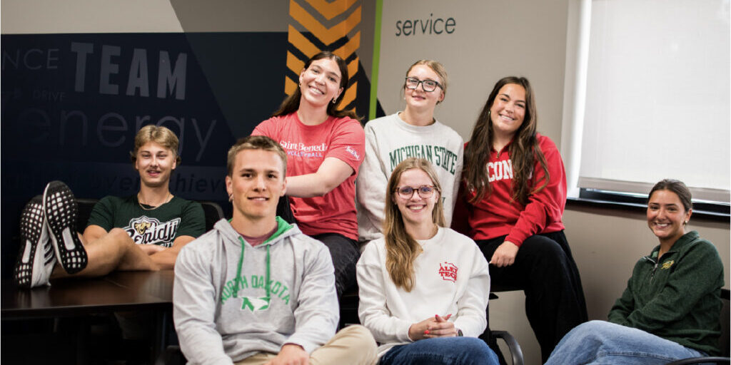 Image of college students around table