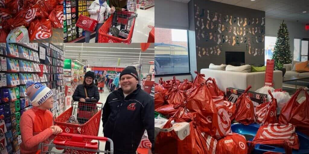 Volunteers with shopping carts full of red gift bags helping families during community giving event at store.