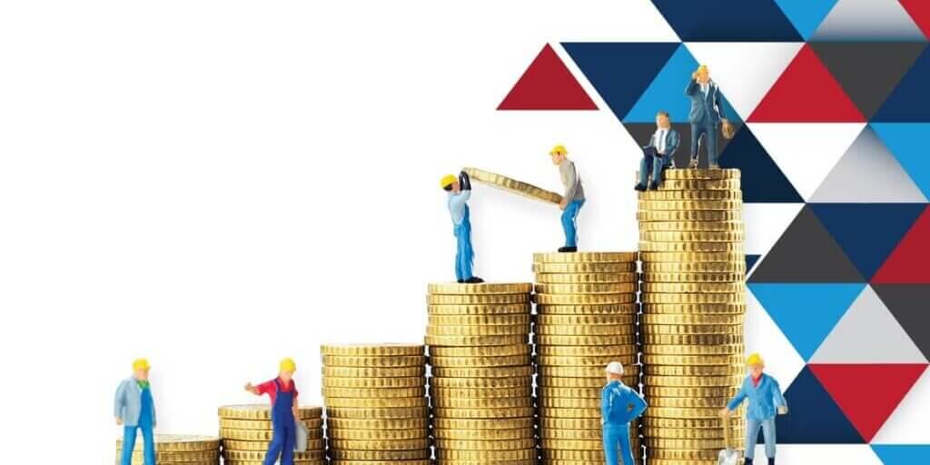 Small worker figurines on graduated stacks of gold coins symbolizing working capital management and growth.